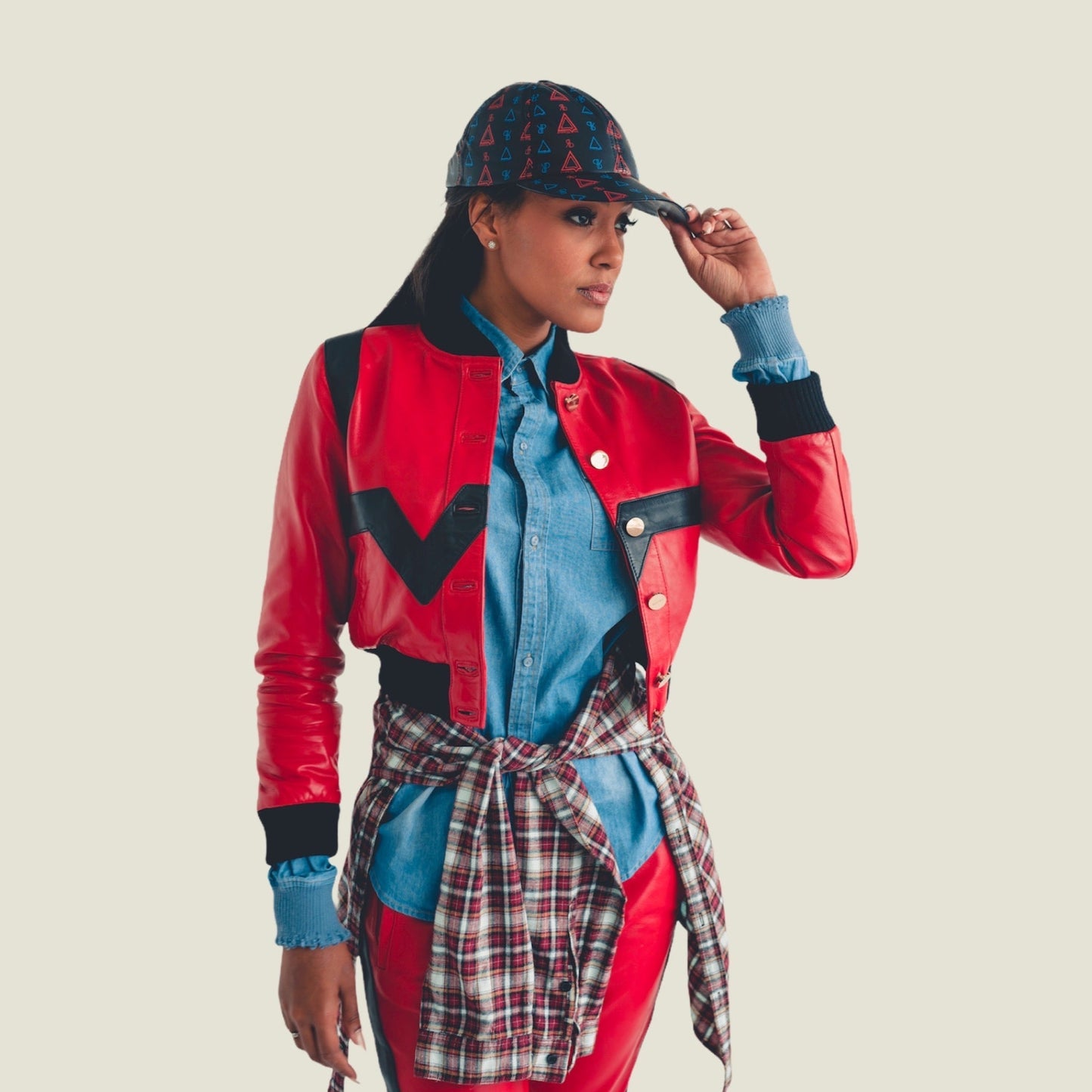 The Cropped Valley Bomber by PRSVR. Red and Black Colorway on female model Sheba. Pyramid Hat by PRSVR
